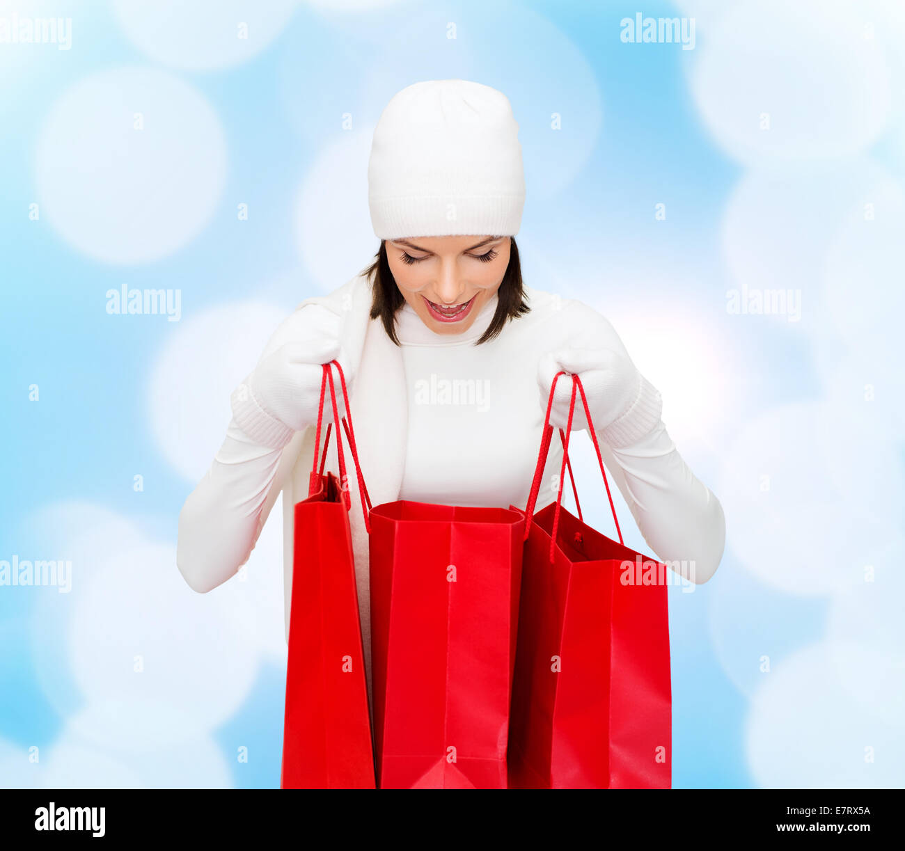 smiling young woman with red shopping bags Stock Photo
