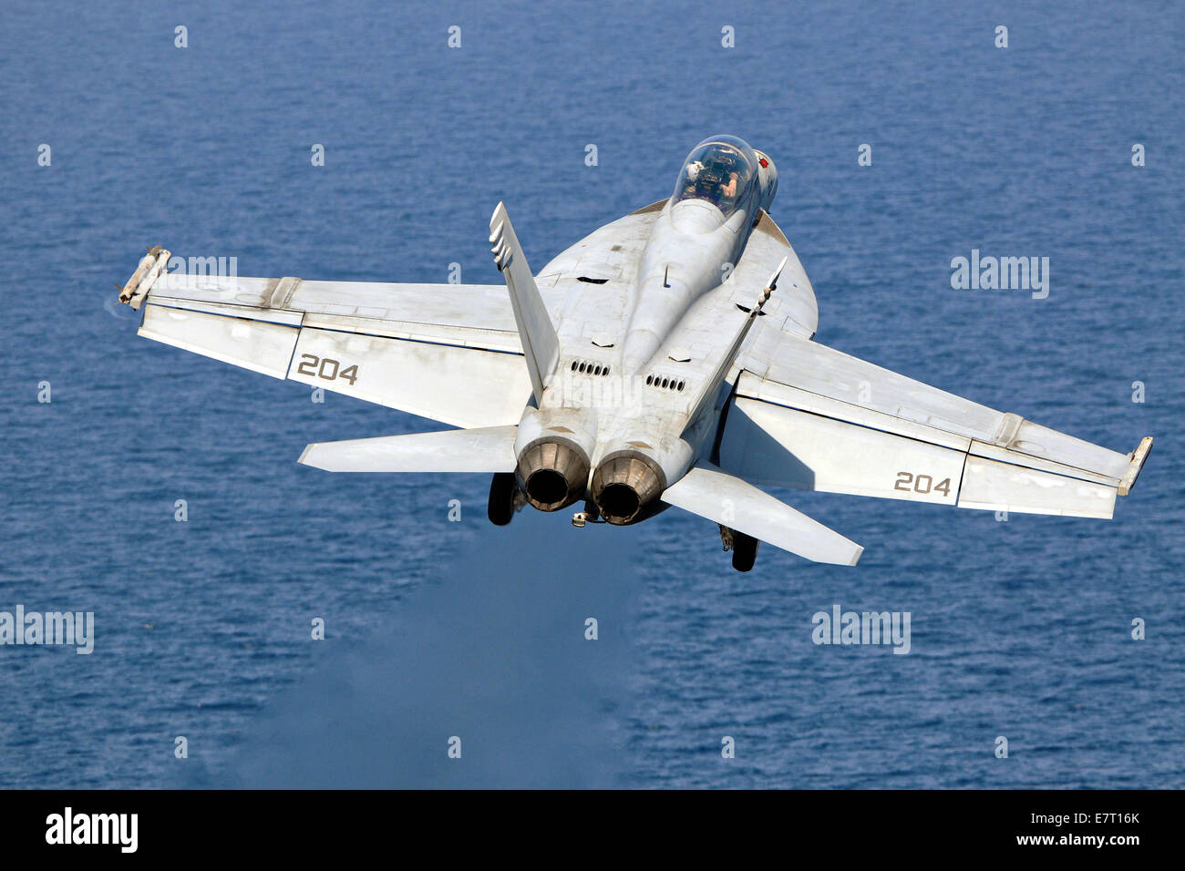 A US Navy F/A-18F Hornet fighter aircraft launches from the flight deck of the aircraft carrier USS George H.W. Bush September 22, 2014 in the Persian Gulf Sept. 22, 2014. The military launched the first direct strikes on ISIS targets inside Syria. Stock Photo