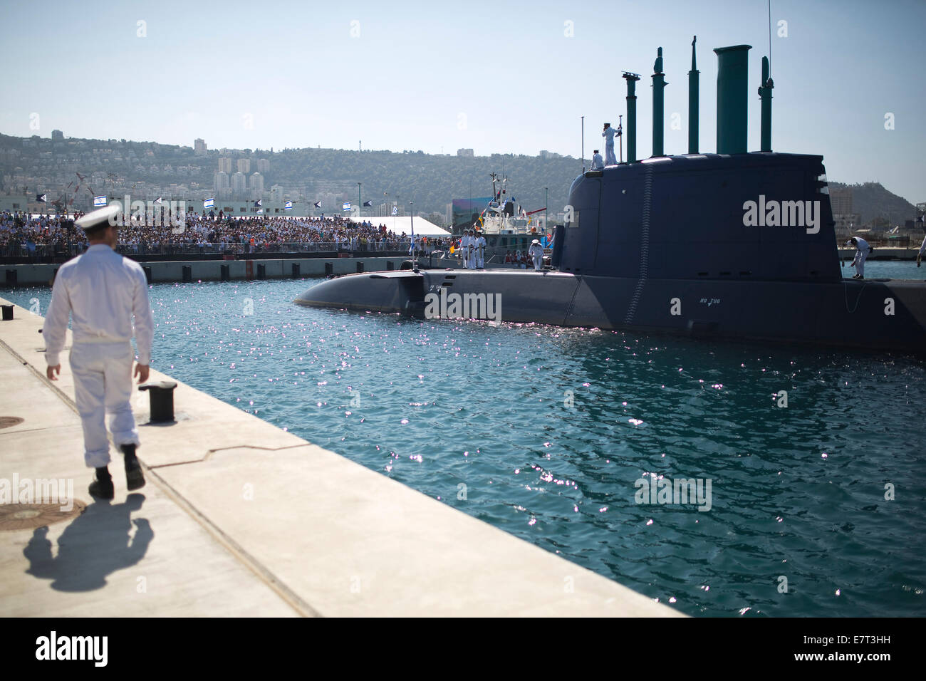 Haifa, Israel. 23rd Sep, 2014. An Israeli naval officer walks on the pier at a naval base in the northern Israeli city of Haifa as INS Tanin, a Dolphin AIP class submarine, docks after its arrival in Israel, on Sept. 23, 2014. The Israeli Navy on Tuesday welcomed the newest addition to its submarine fleet, INS Tanin, a fourth German-made vessel that military and defense officials say will dramatically boost Israel's ability to operate against foes near and far, local media reported. Credit:  POOL/Amir Cohen/Xinhua/Alamy Live News Stock Photo