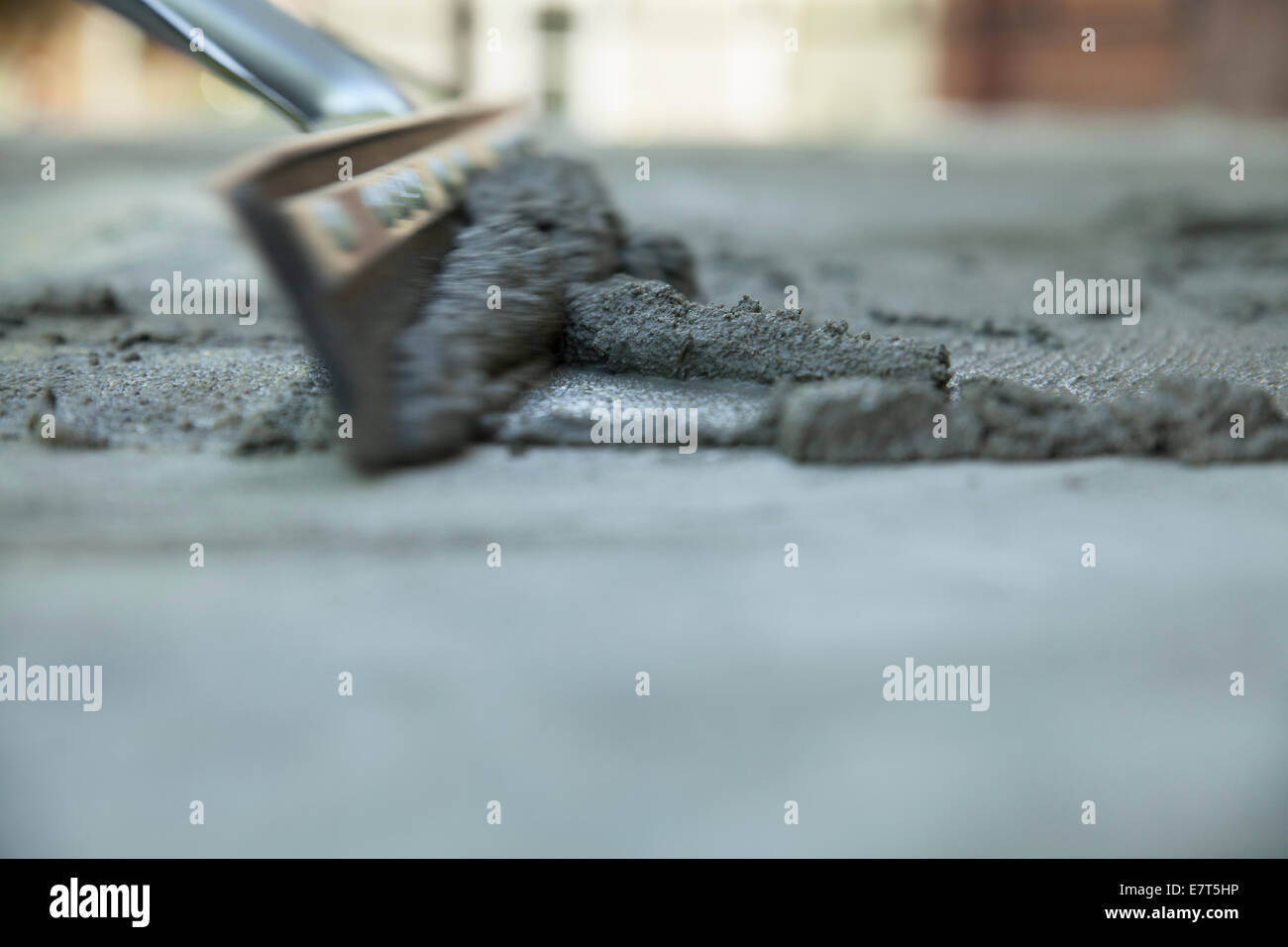 Workman smooths  a skim coating of cement on old stairway. Stock Photo