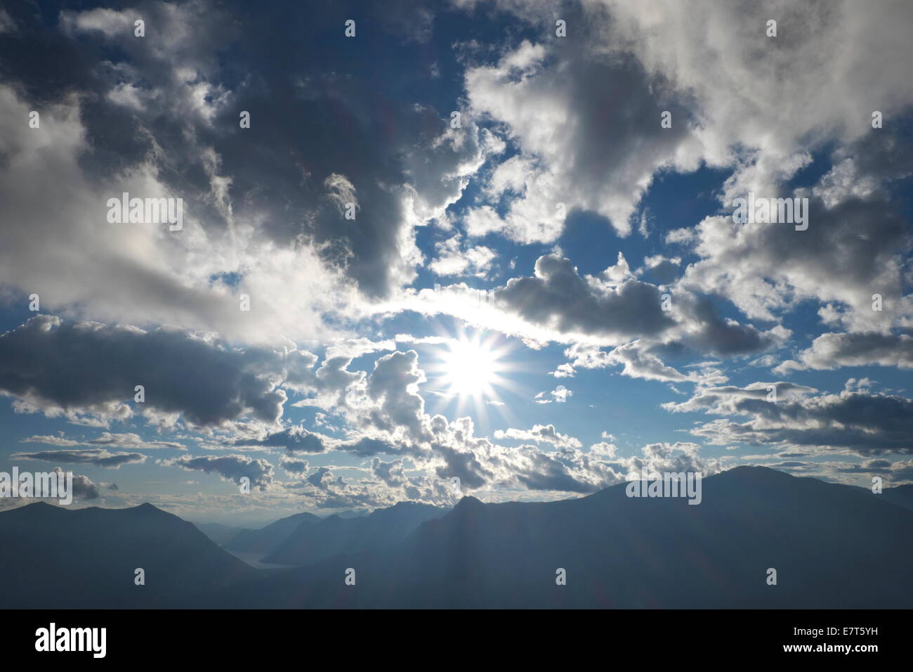 Sun, clouds and shadows over the mountains, Italy Stock Photo