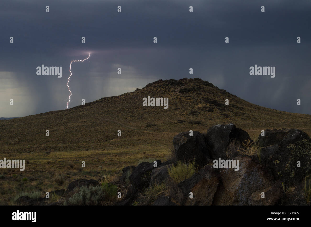 Monsoon storm with lightning over JA Volcano, Volcanoes Day Use Area, Petroglyph National Monument, Bernalillio co., New Mexico. Stock Photo