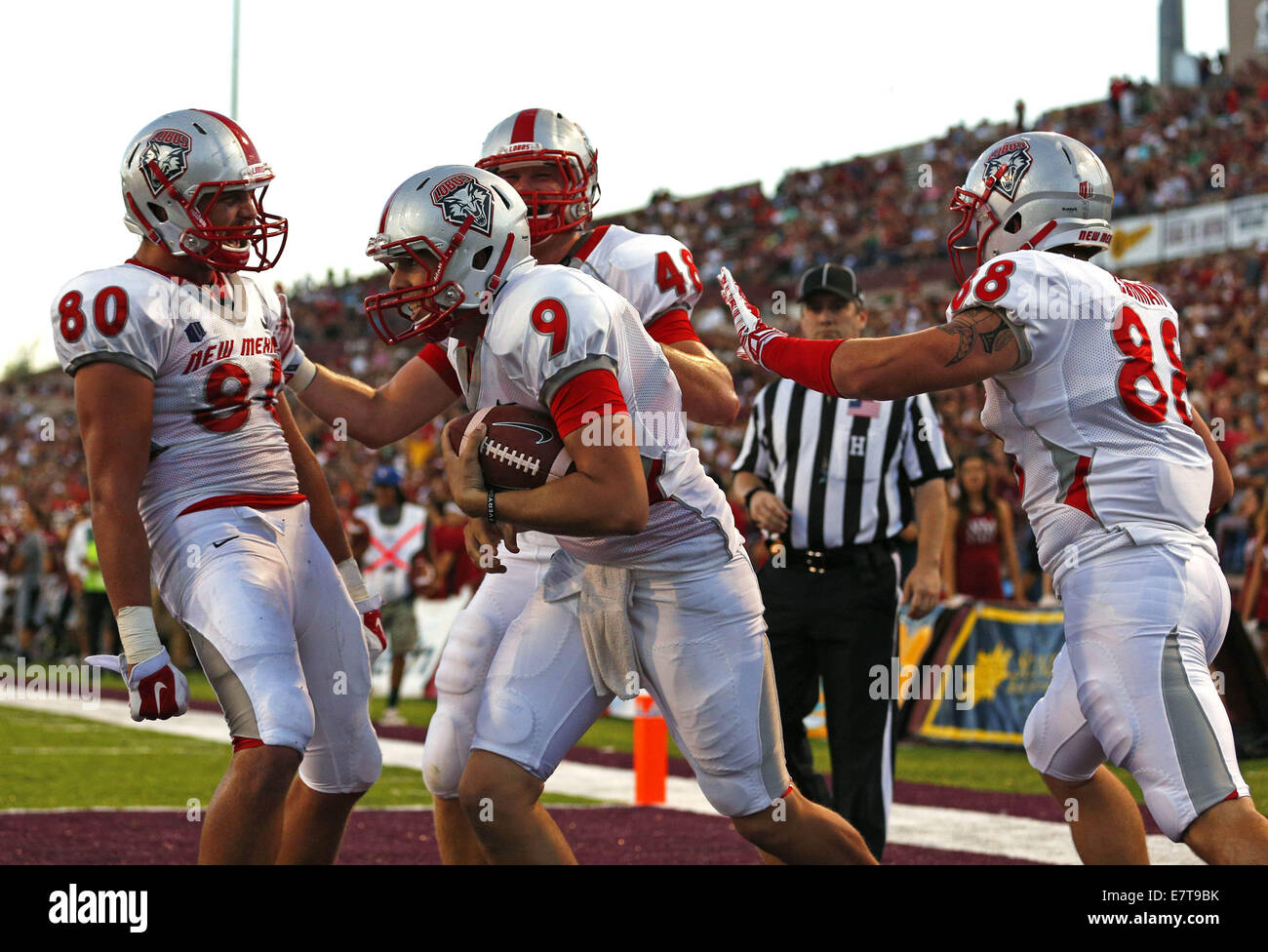 Las Cruces, NM, USA. 20th Sep, 2014. New Mexico holder Quinton McCown (9) is congratulated by teammates Reece White (80), Nick Lehman (88) and Chris Edling after scoring a touchdown on a fake field goal attempt during the football game against New Mexico State at the Aggie Memorial Stadium in Las Cruces, Saturday, Sept. 20, 2014. The Lobos won 38-35. © Andres Leighton/Albuquerque Journal/ZUMA Wire/Alamy Live News Stock Photo