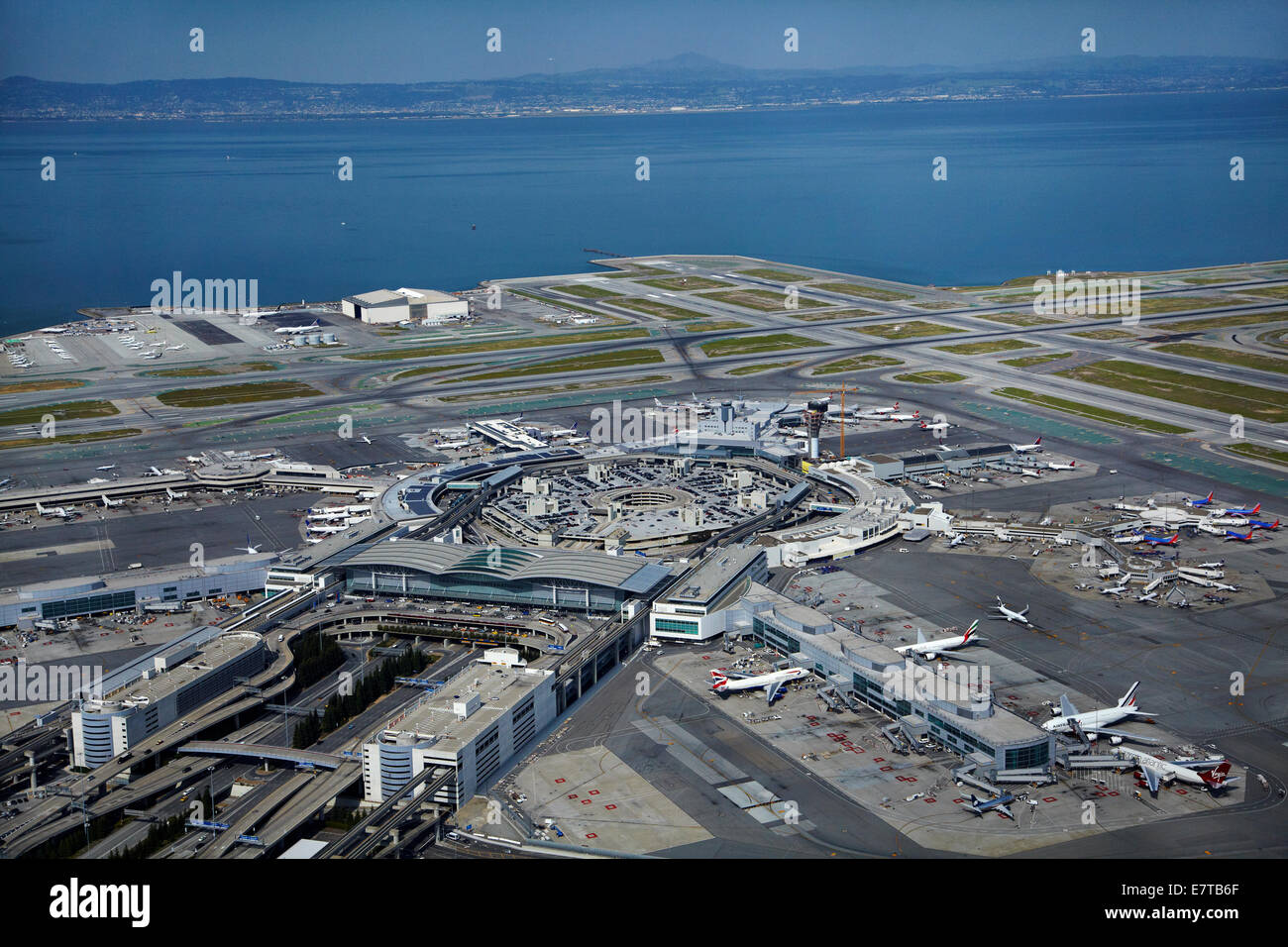 Planes, terminals and runways at San Francisco International Airport, San Francisco, California, USA - aerial Stock Photo