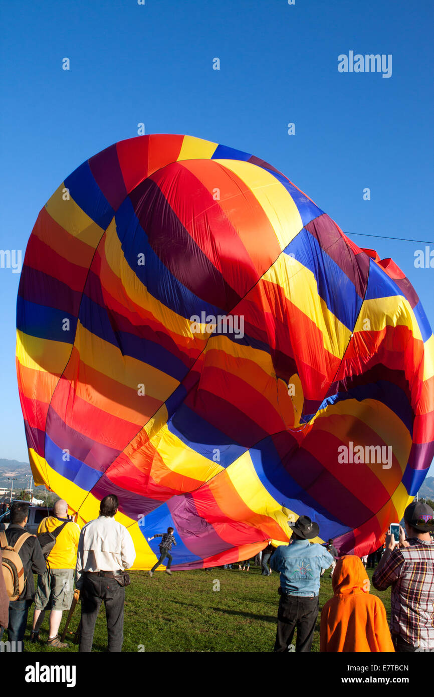 Wind gusts collapse a partially inflated hot-air balloon Stock Photo