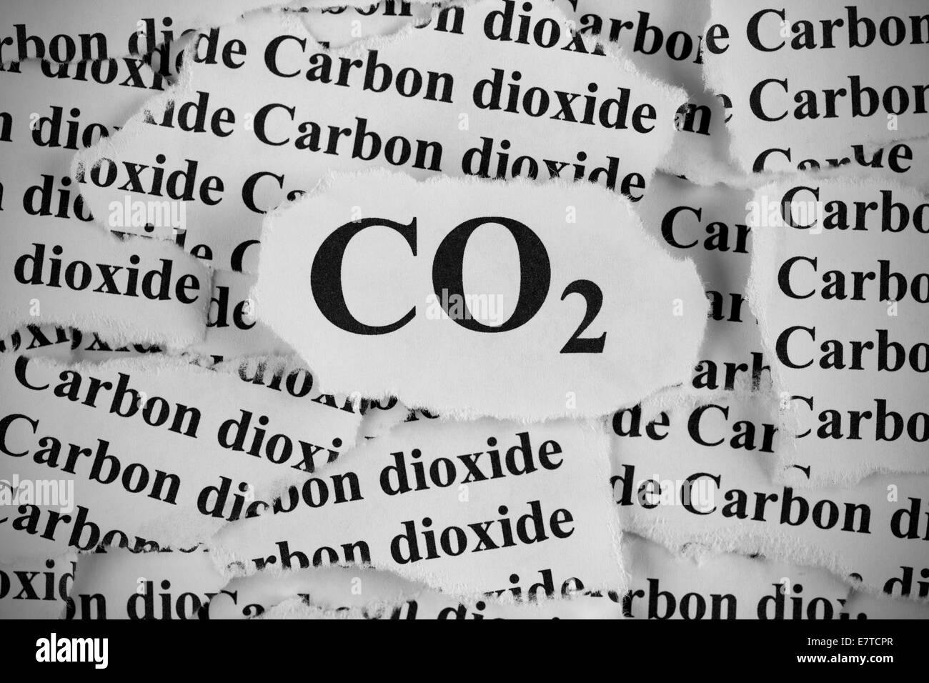 Carbon Dioxide. Torn pieces of paper with the words 'CO2' and 'Carbon Dioxide'. Black and White. Close-up. Stock Photo