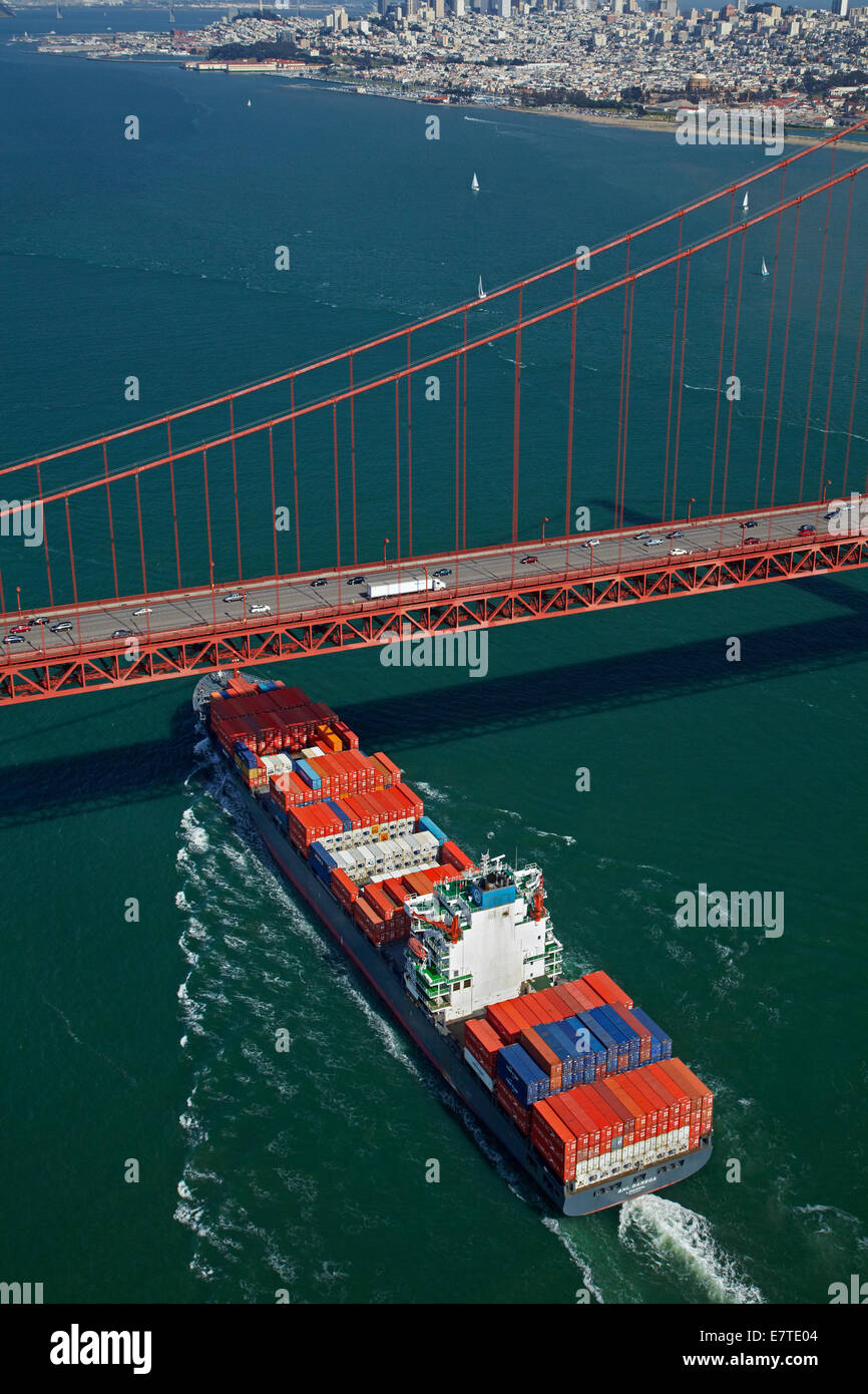 Container ship passing under Golden Gate Bridge, San Francisco Bay, San Francisco, California, USA - aerial Stock Photo