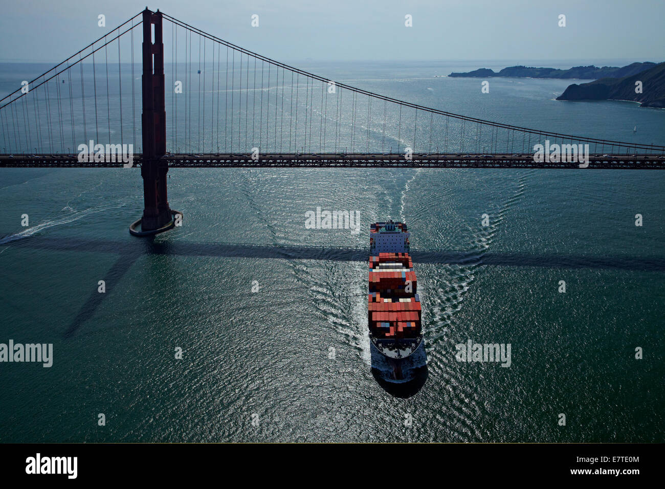 Container ship passing under Golden Gate Bridge, San Francisco Bay, San Francisco, California, USA - aerial Stock Photo
