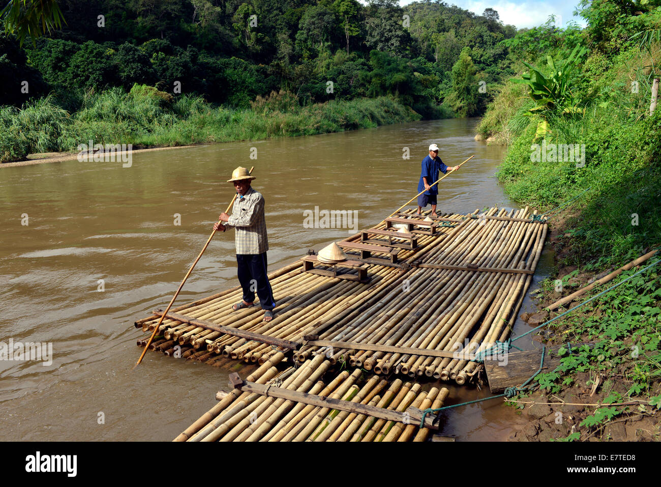 Raft drivers on a bamboo raft on the Mae Tang River, Chiang Mai Province, Northern Thailand