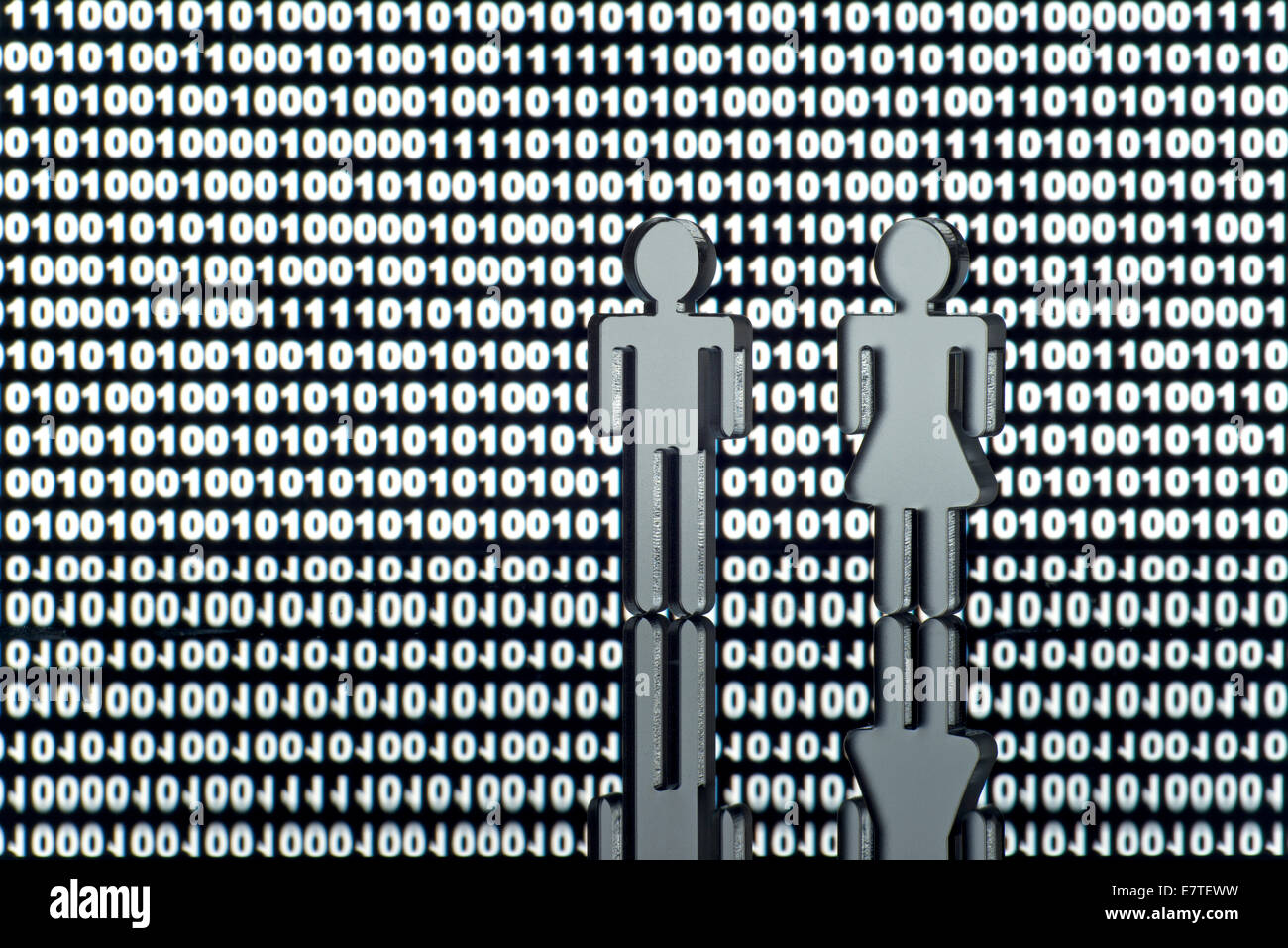Two figures in front of binary code Stock Photo