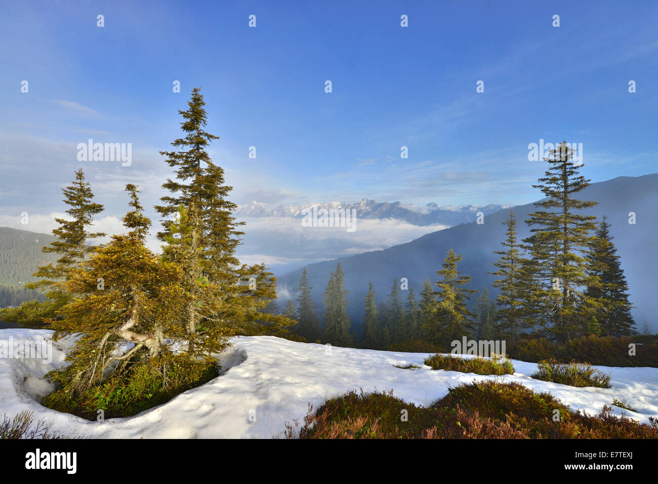 Mountain landscape with snow, at the back the Inn Valley and at the far back the Karwendel Range, from Mt Kleiner Gamsstein Stock Photo