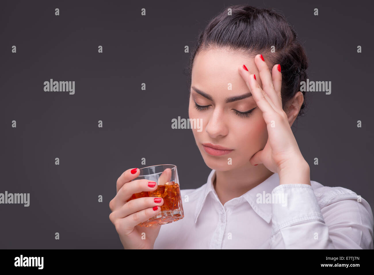 Serious woman wearing white blouse Stock Photo