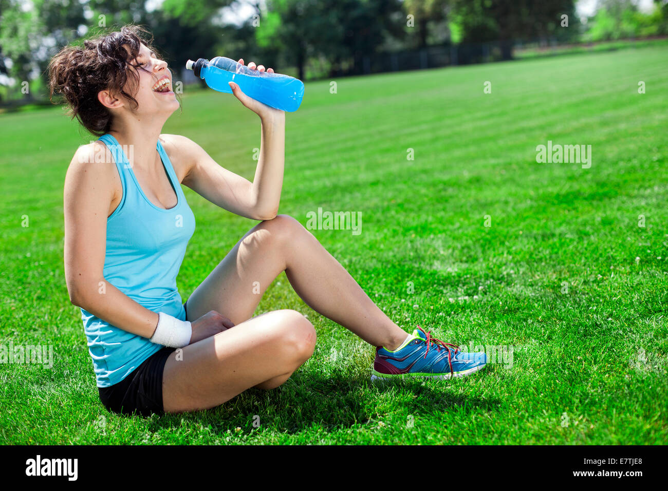 Tired Woman Runner Taking A Rest After Run Drinking Water Stock Photo