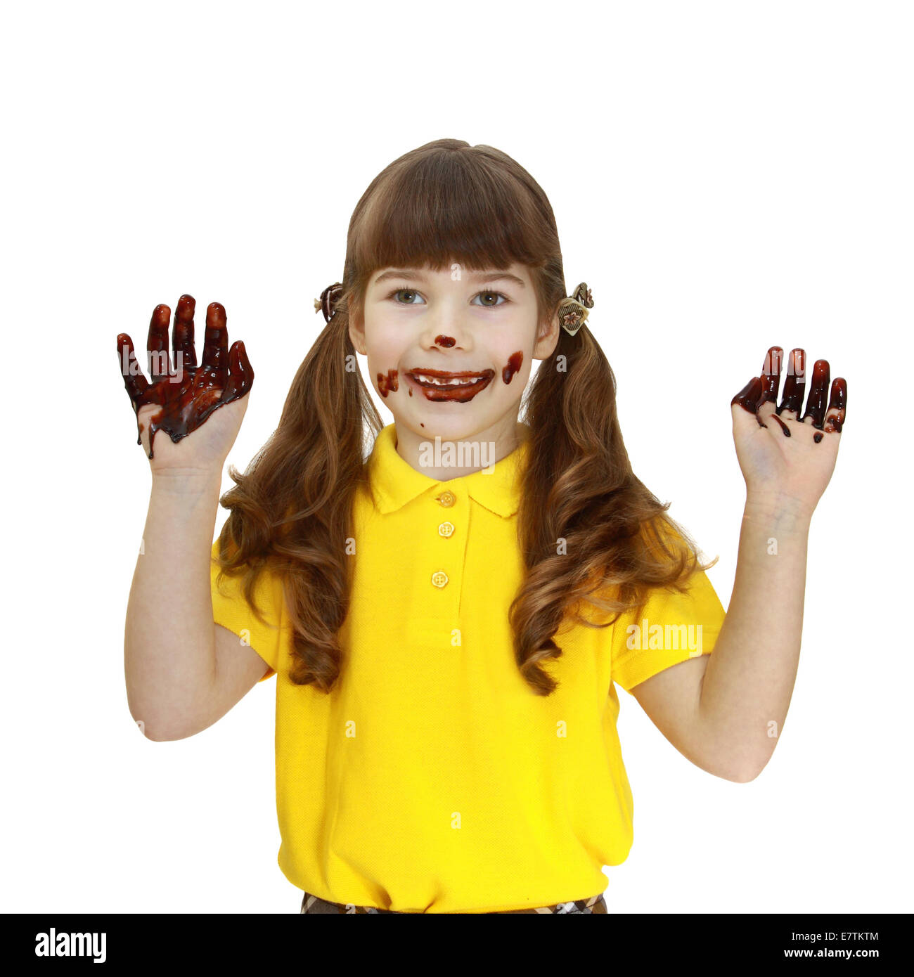 Girl with face and hands stained in chocolate isolated on white background Stock Photo