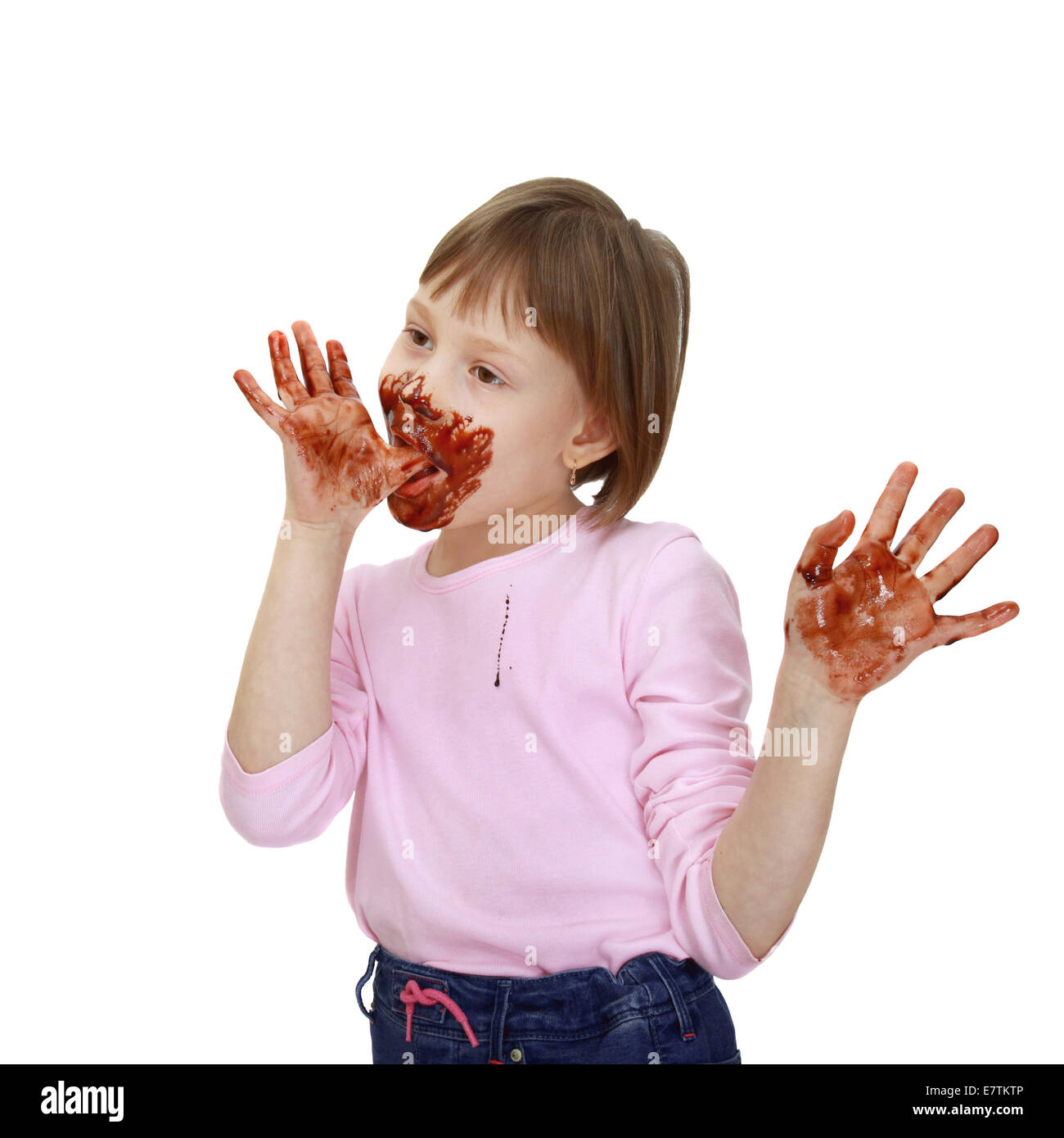 Girl soiled in chocolate chews over fingers isolated on white background Stock Photo