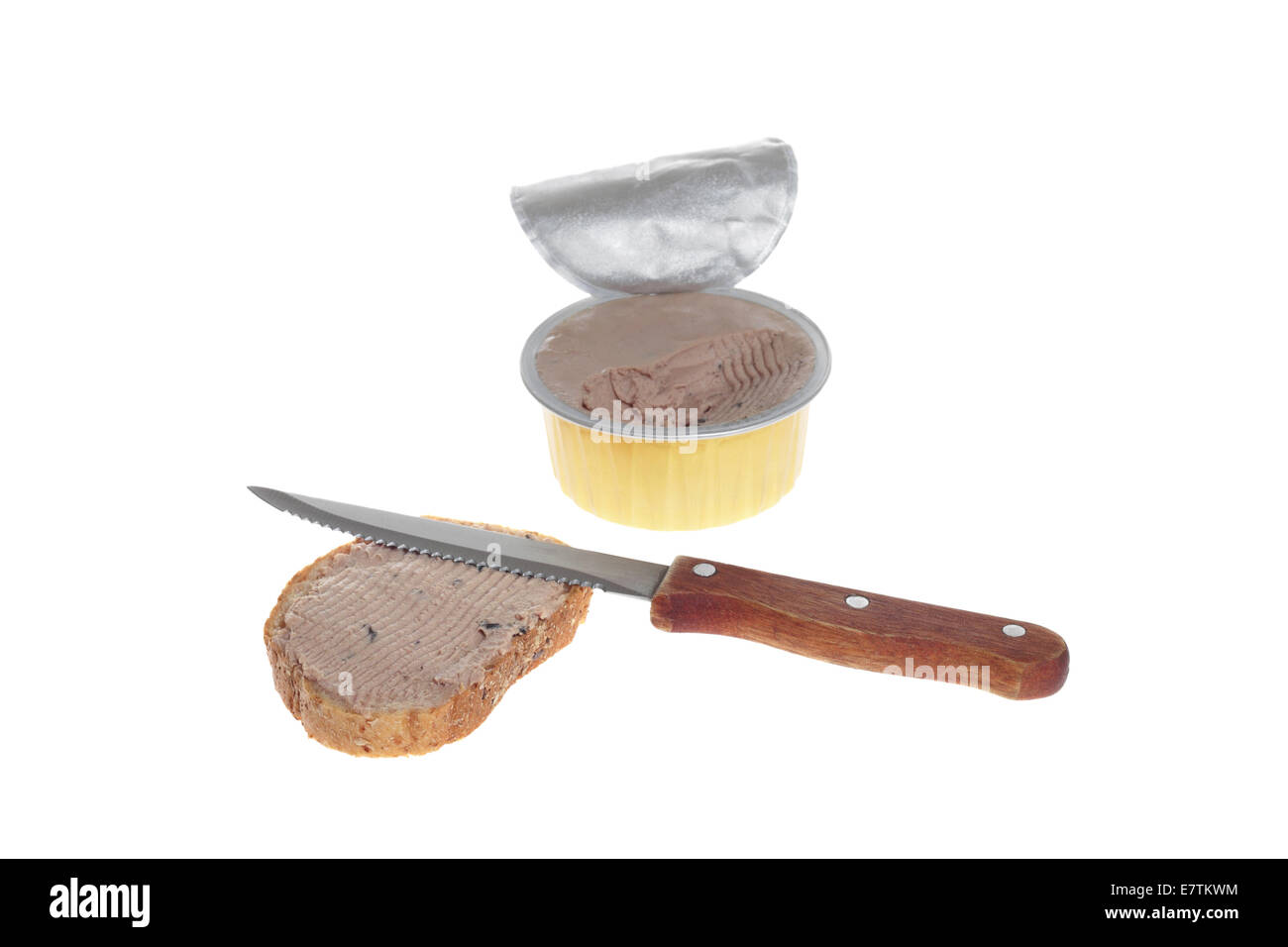 Pate in open can partially eaten with knife and bread smeared with pate isolated on white background Stock Photo