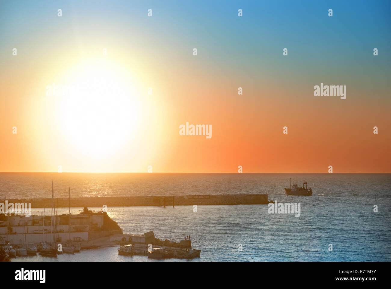 Boat and beautiful colorful sunset above the sea Stock Photo - Alamy