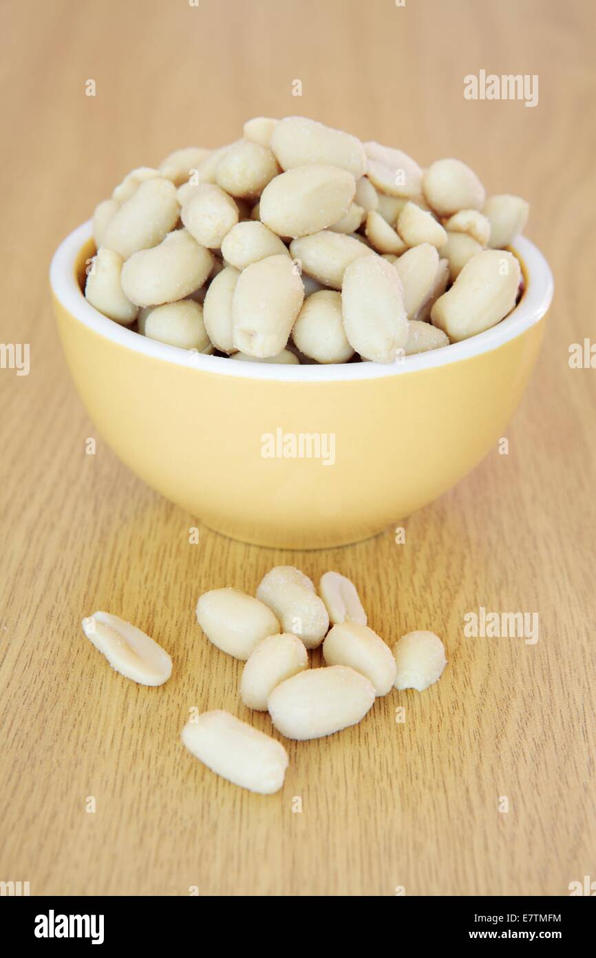Salted peanuts (Arachis hypogaea) in bowl. Stock Photo