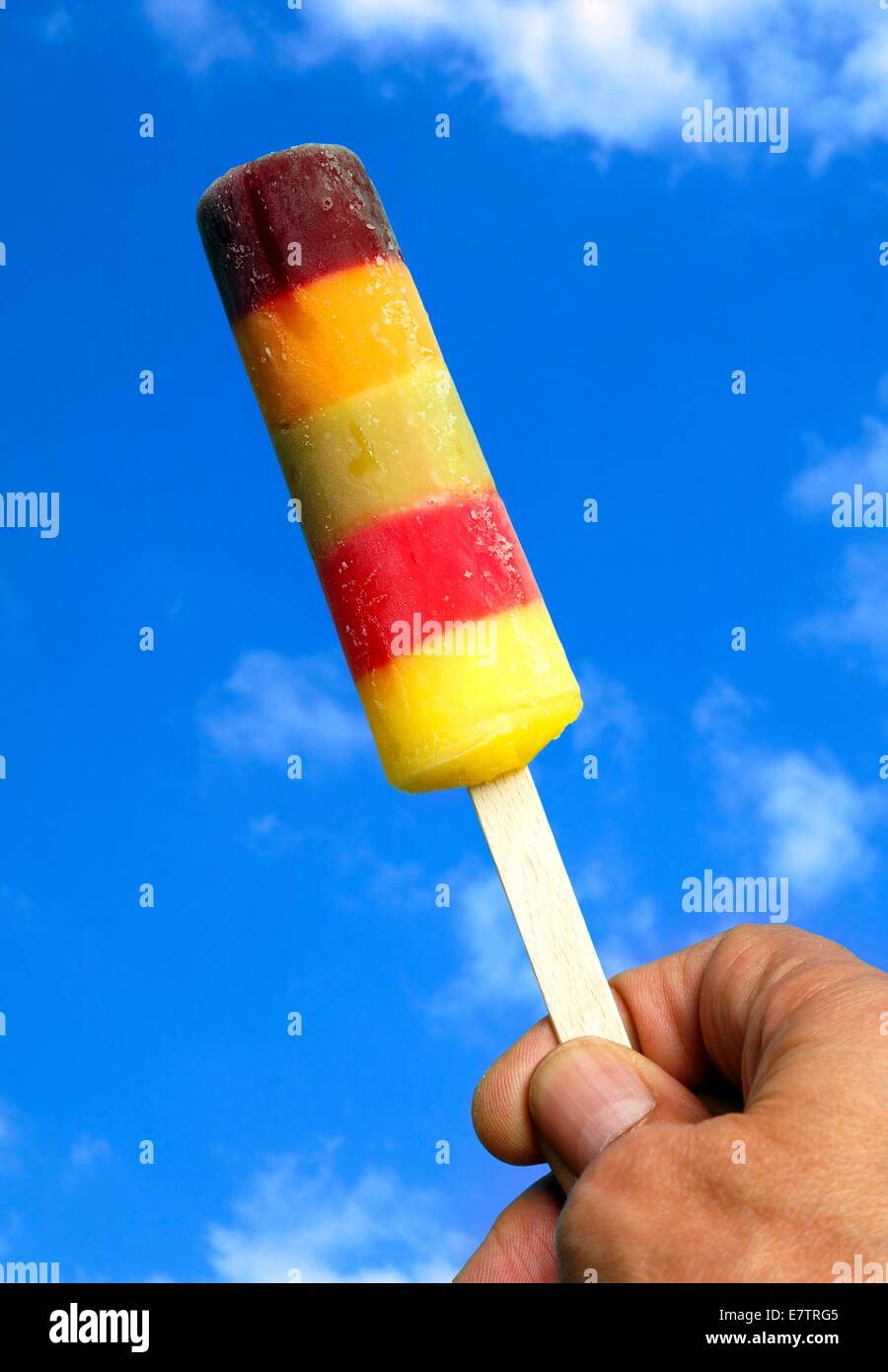 Person holding ice lolly. Stock Photo