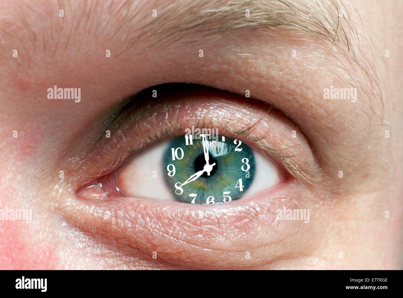 MODEL RELEASED. Eye with clock, composite image. Stock Photo