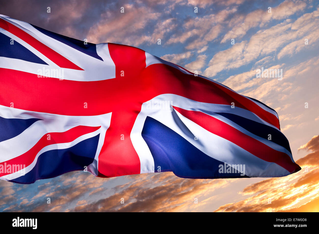 An image of a 'Union Jack' - Union Flag of Great Britain against a new dawn sunrise. Stock Photo