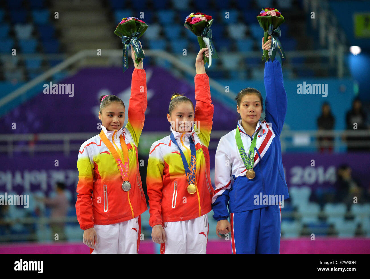 Incheon, South Korea. 24th Sep, 2014. Gold medalist Yao Jinnan (C) of China, silver medalist Huang Huidan (L) of China and bronze medalist Kang Yongmi of the Democratic People's Republic of Korea pose during the awarding ceremony the women's uneven bars contest of gymnastics artistic event at the 17th Asian Games in Incheon, South Korea, Sept. 24, 2014. Yao Jinnan claimed the title with 15.466 points. Credit:  Zhu Zheng/Xinhua/Alamy Live News Stock Photo