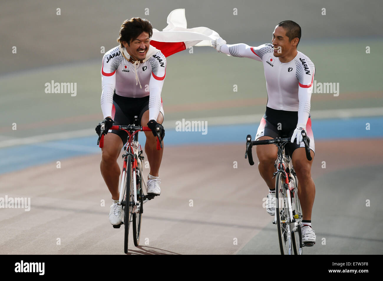 Incheon, South Korea. 24th Sep, 2014. Nakagawa Seiichiro (L) and Kawabata Tomoyuki of Japan celebrate victory after the men's sprint finals of cycling track competition at the 17th Asian Games in Incheon, South Korea, Sept. 24, 2014. Nakagawa Seiichiro and Kawabata Tomoyuki won the gold and silver medal respectively. Credit:  Huang Zongzhi/Xinhua/Alamy Live News Stock Photo