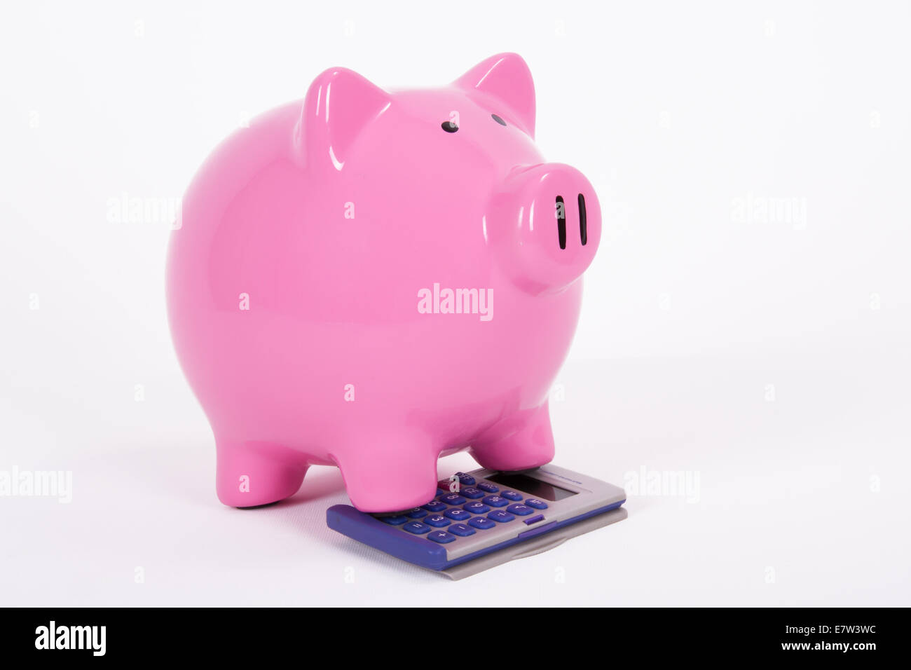 Pink piggy bank on the calculator, isolated on white background Stock ...