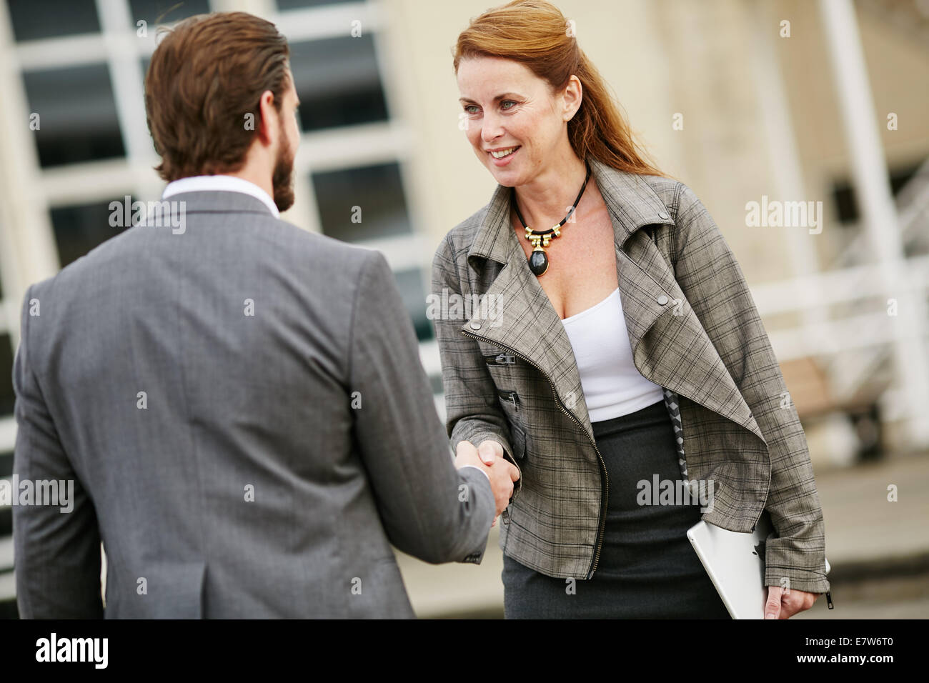 Two business people greeting each other Stock Photo
