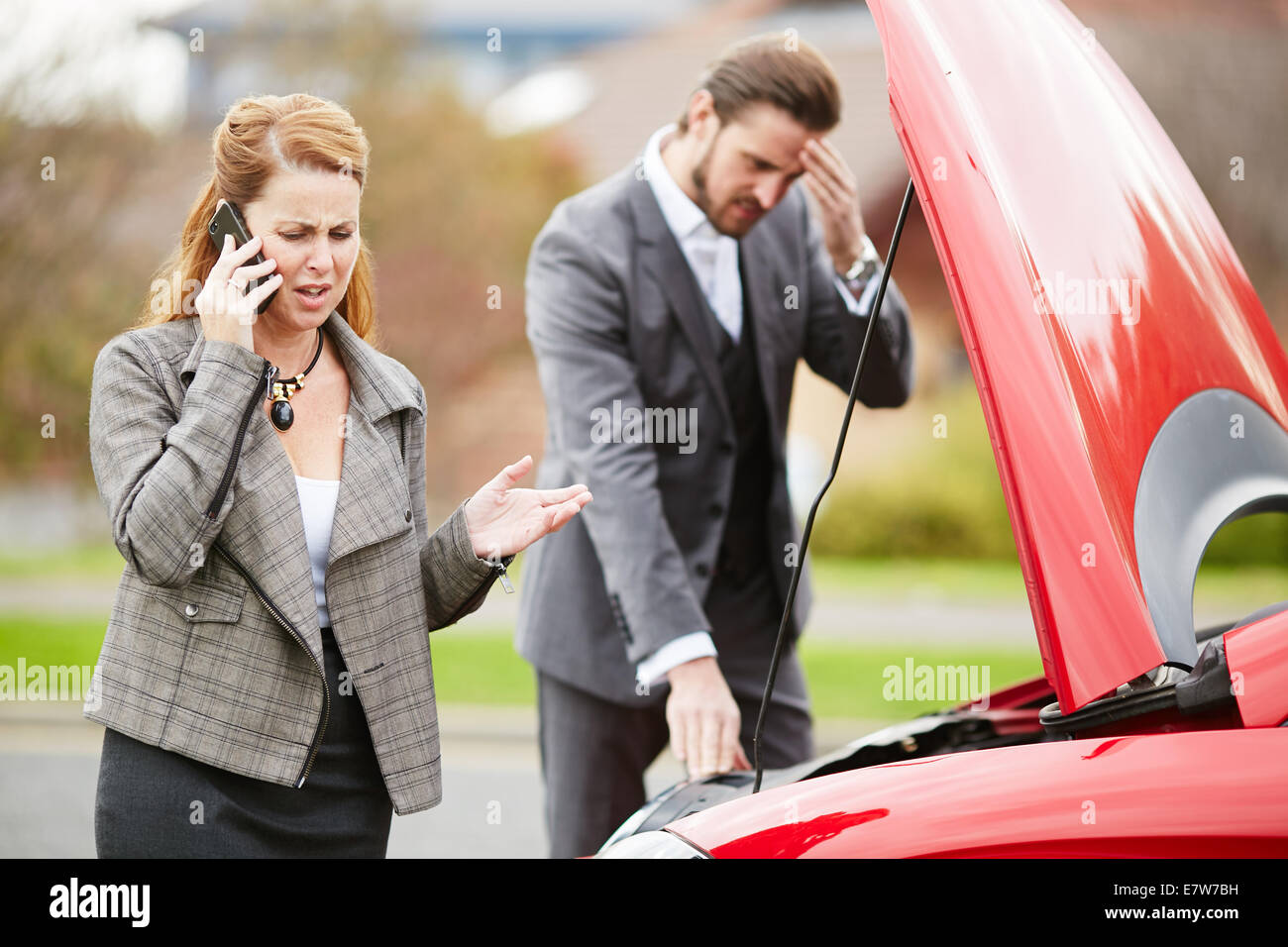 Couple with broken down car Stock Photo