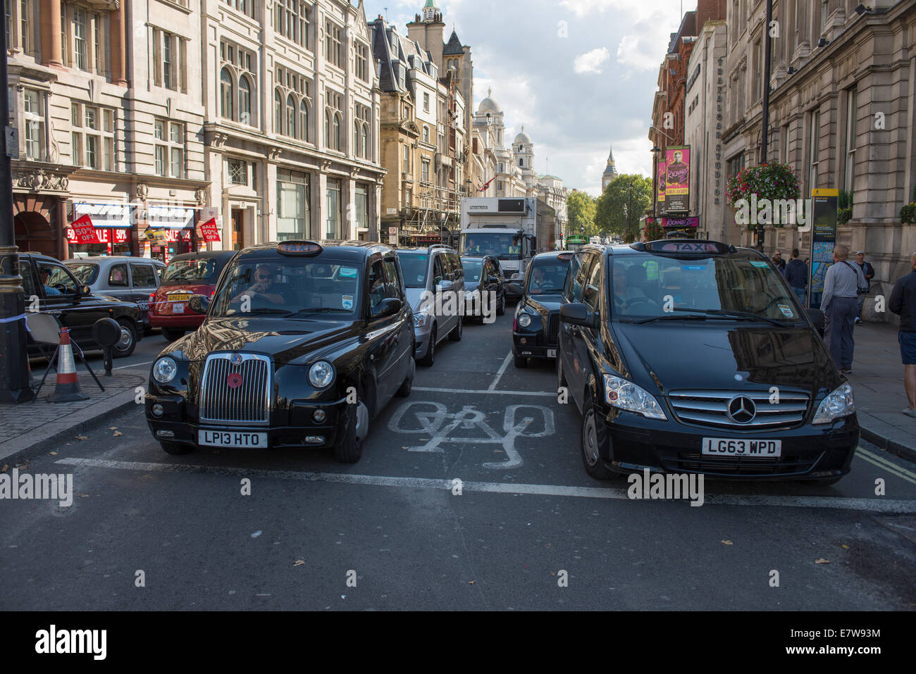 Central London, UK. 24th September 2014. Black cab taxi drivers protest TfL’s taxi policies today by driving in central London at a snails pace around 2pm. Areas affected are around Parliament Square, Whitehall and Trafalgar Square. Taxis line up on both sides of Whitehall. Credit:  Malcolm Park editorial/Alamy Live News. Stock Photo