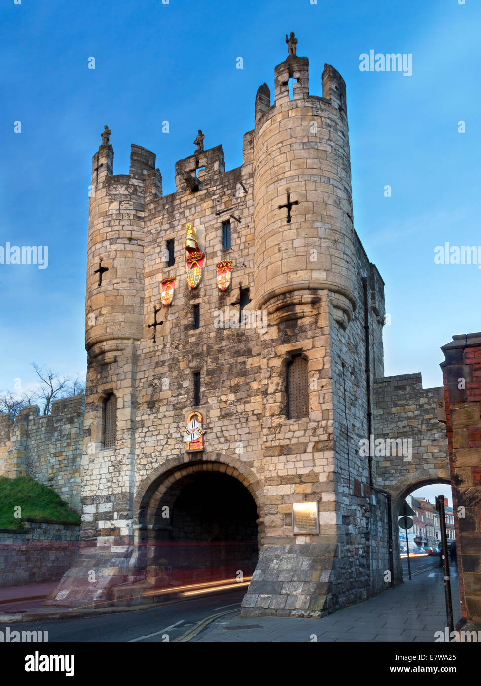 Micklegate Bar and traffic light trails at dusk, in York, North Yorkshire, England. Stock Photo