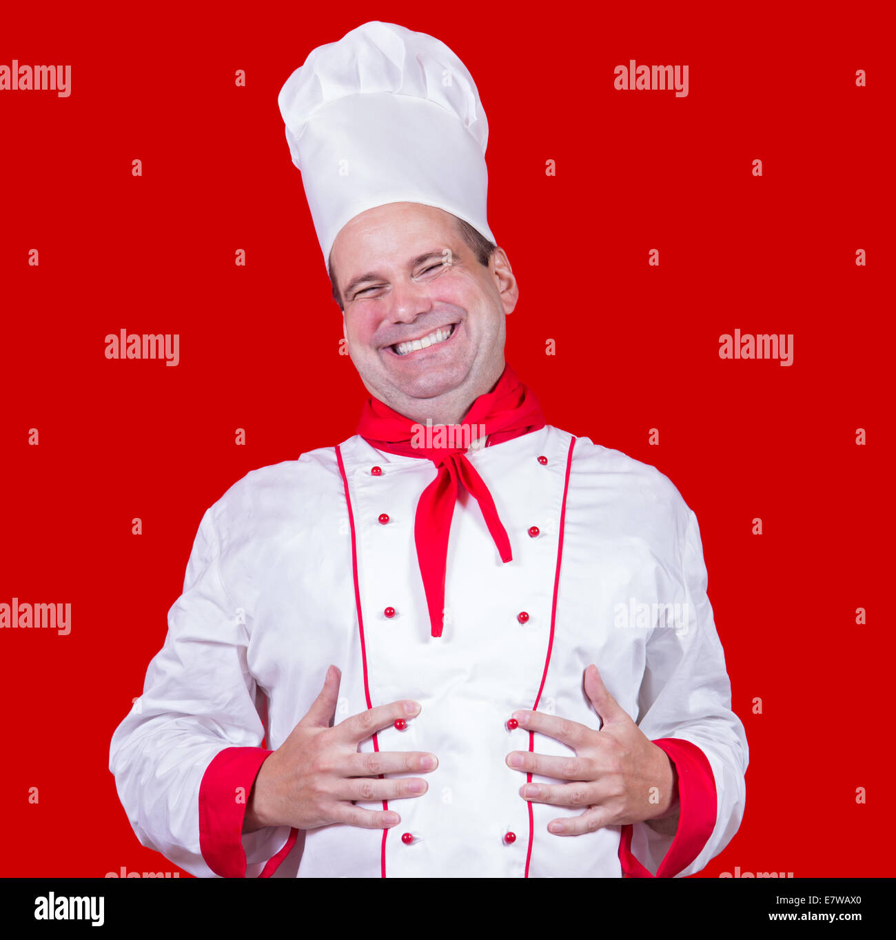 happy chef holding hands on his belly Stock Photo