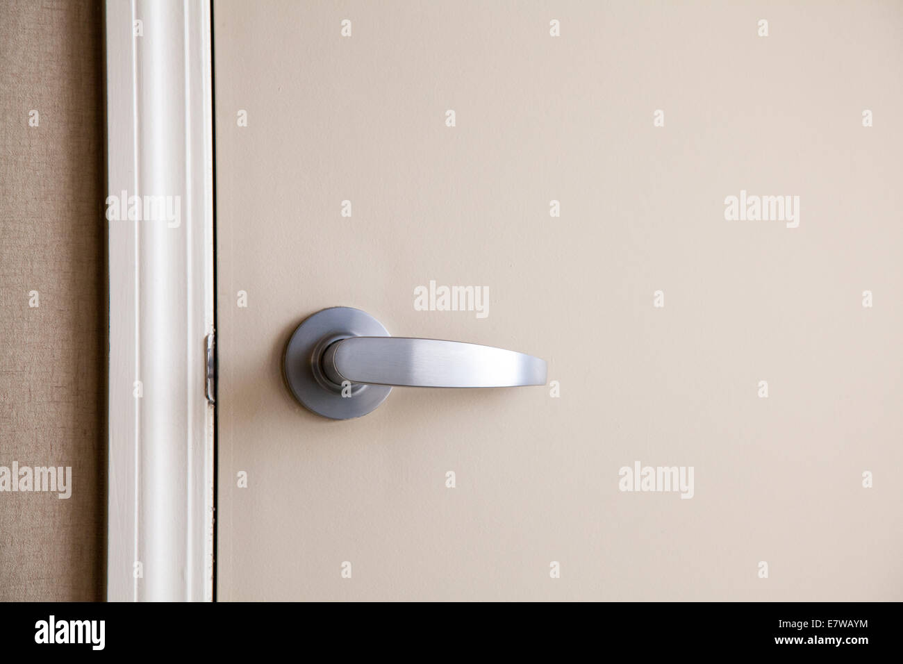 Silver Door Handle on Neutral Color Door Stock Photo