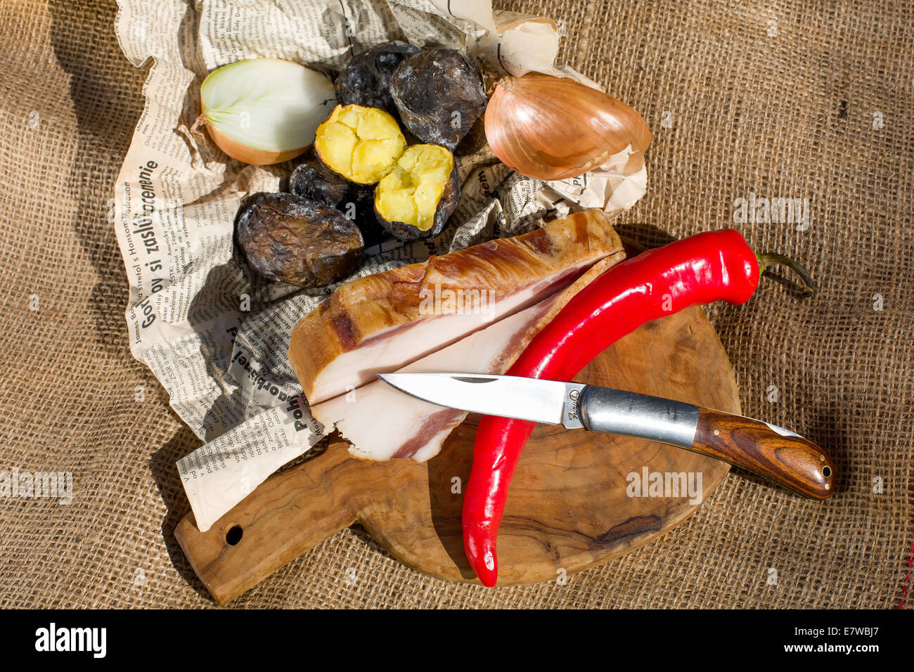 Farmers lunch - bacon, potatoes baked in the embers, peppers and onions Stock Photo