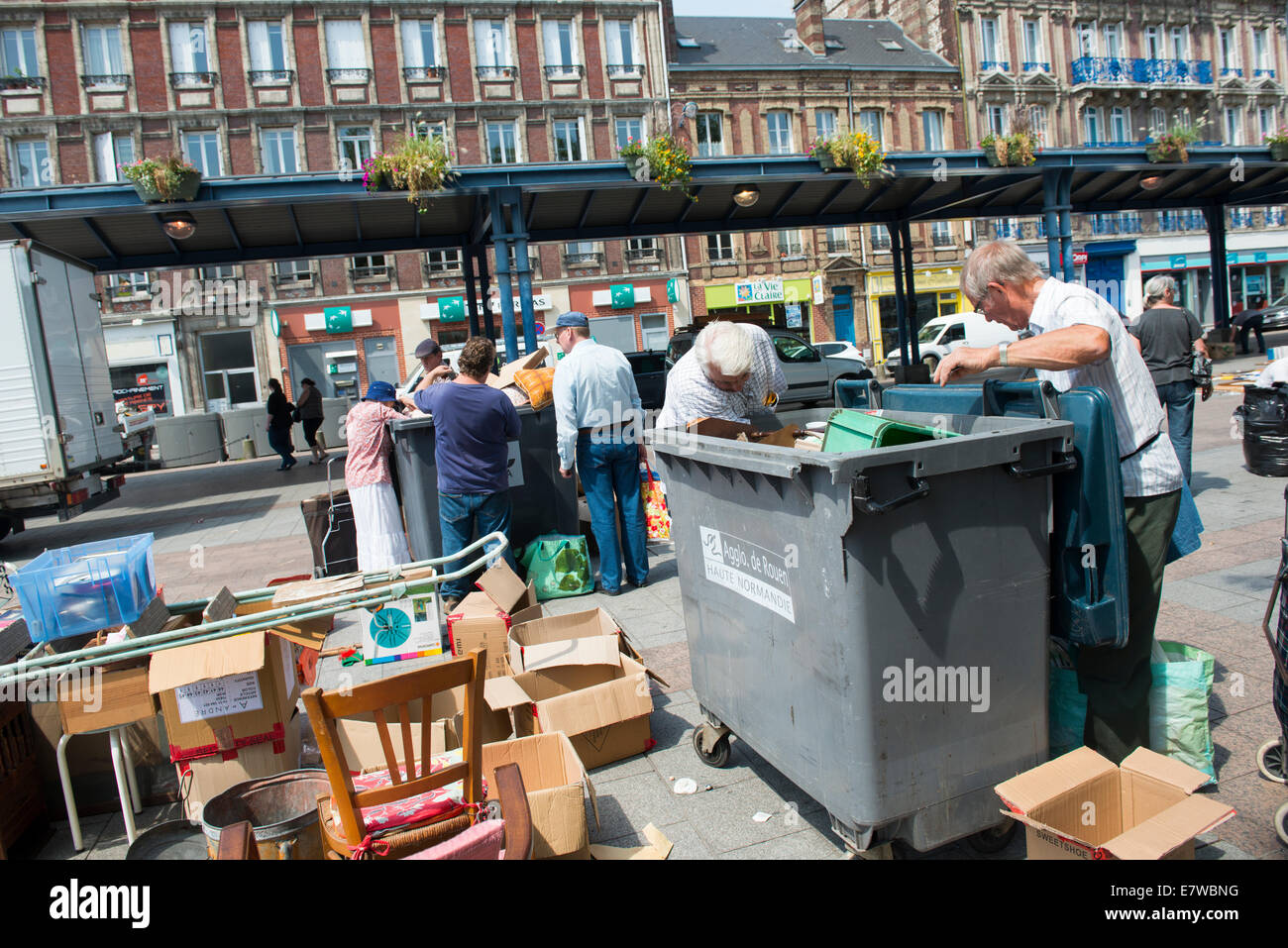 People looking through bins at a market in Rouen, France Europe Stock Photo