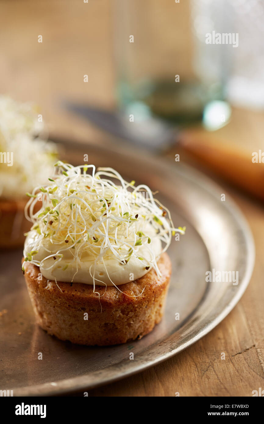 Individual carrot cake with cheese cream and sprouts Stock Photo
