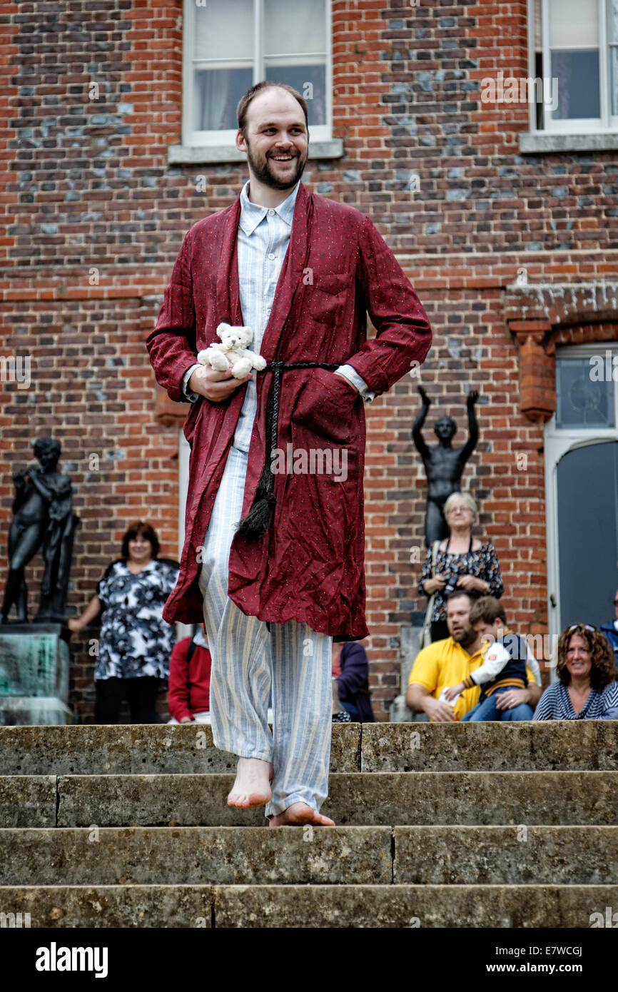 A bearded man with teddy bear models 1940's war time pajamas (pyjama) and dressing gown at Hughenden Manor Stock Photo