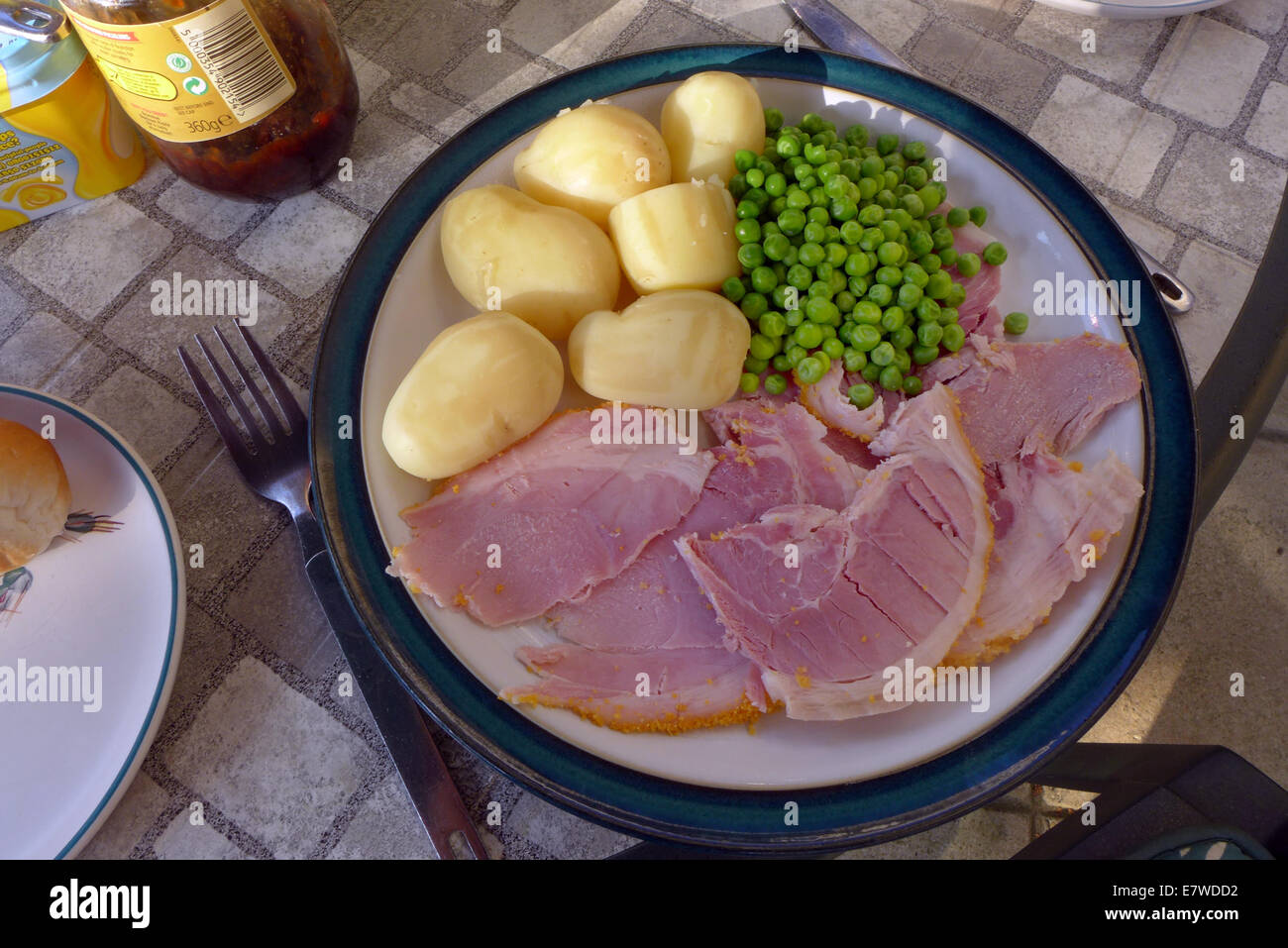A plate of homecooked ham new potatoes and peas Stock Photo Alamy