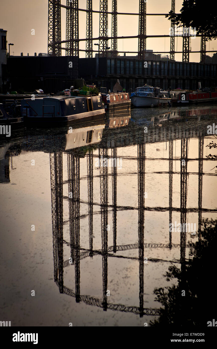 Empty gasometer reflected in canal Stock Photo - Alamy