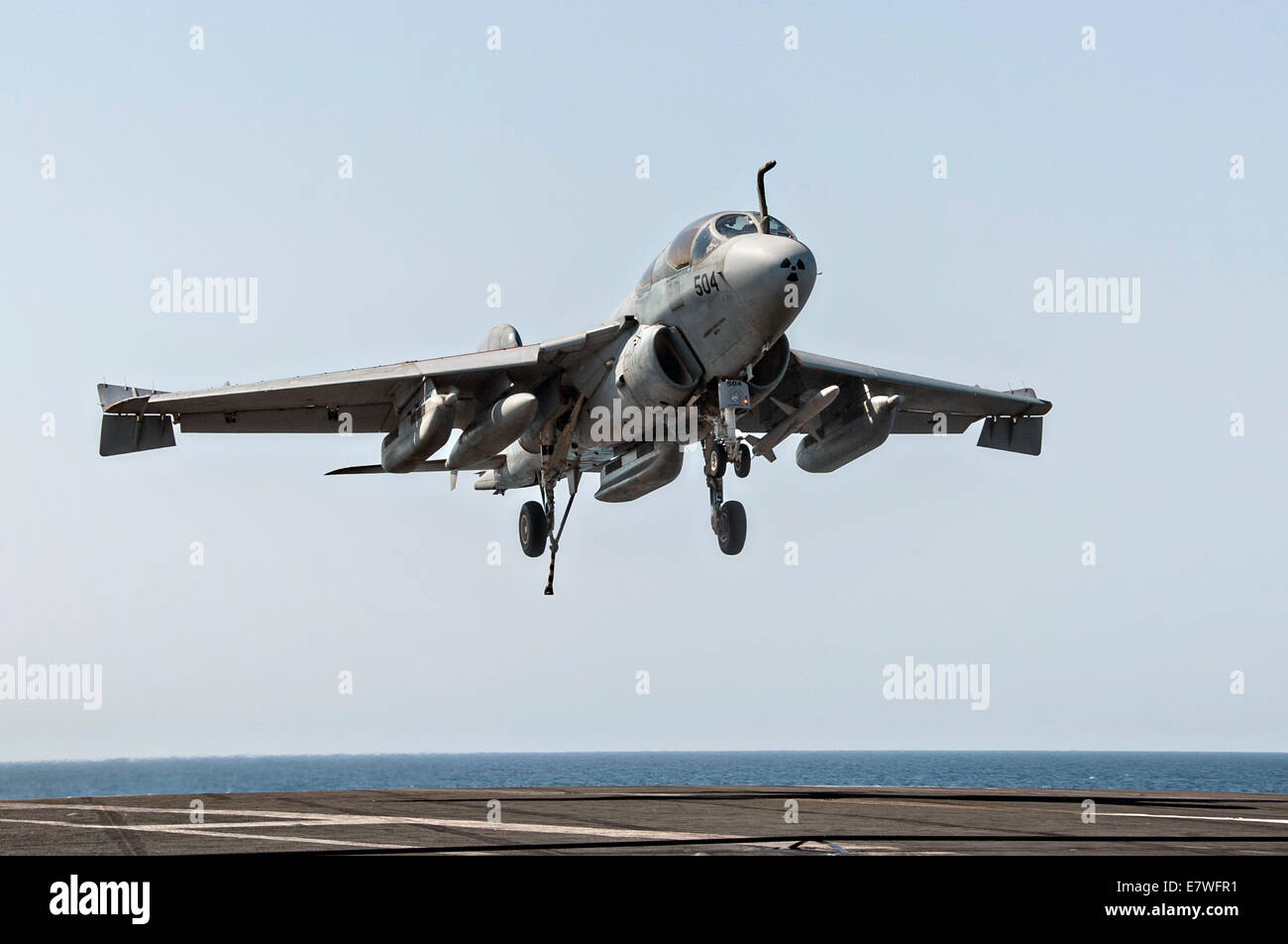A US Navy EA-6B Prowler electronic attack aircraft lands on the flight deck of the aircraft carrier USS George H.W. Bush after returning from a combat sortie against ISIS targets September 23, 2014 in the Persian Gulf. The military launched the first direct strikes on ISIS targets inside Syria. Stock Photo