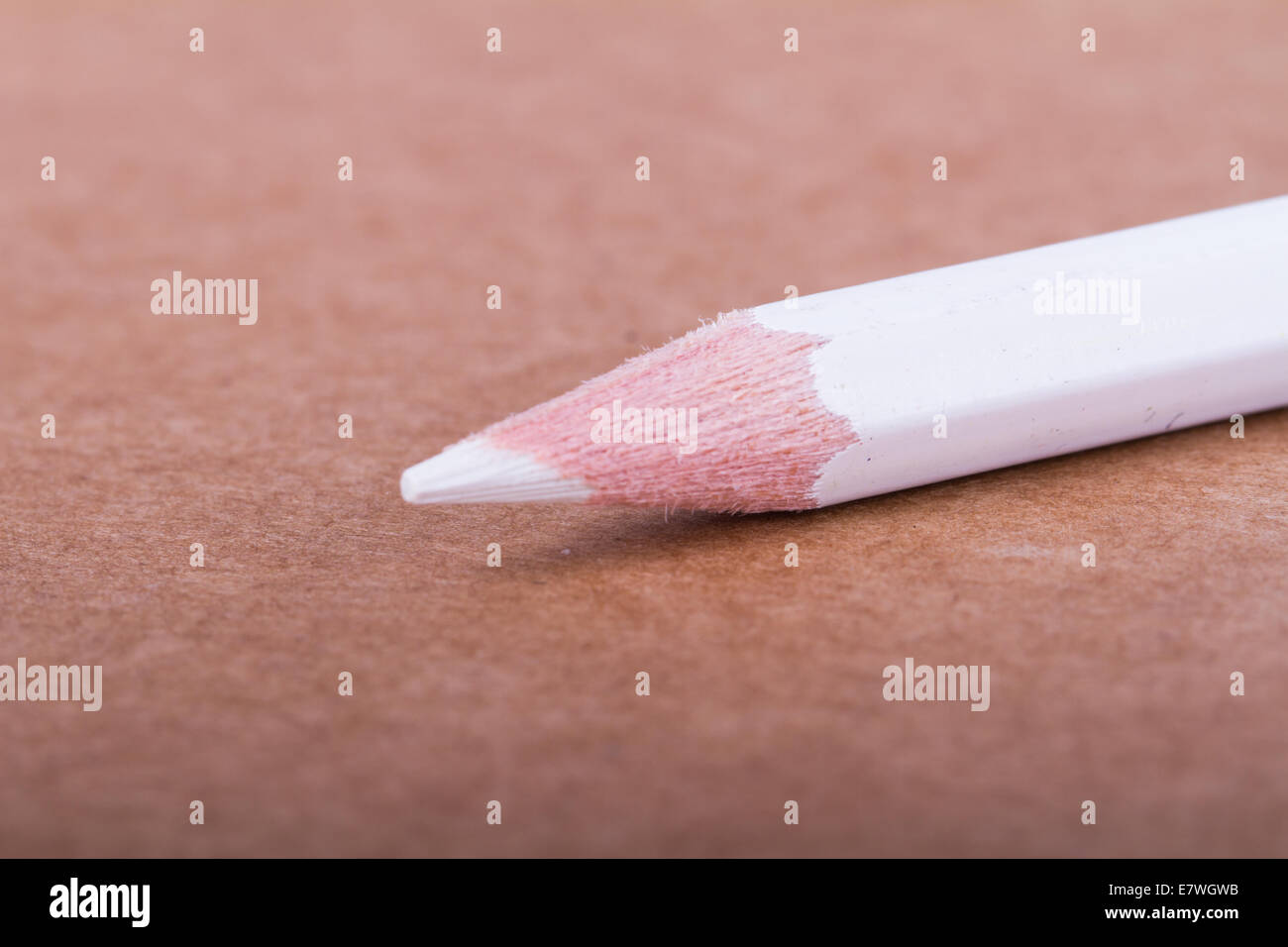 White pencil on textured background. Stock Photo