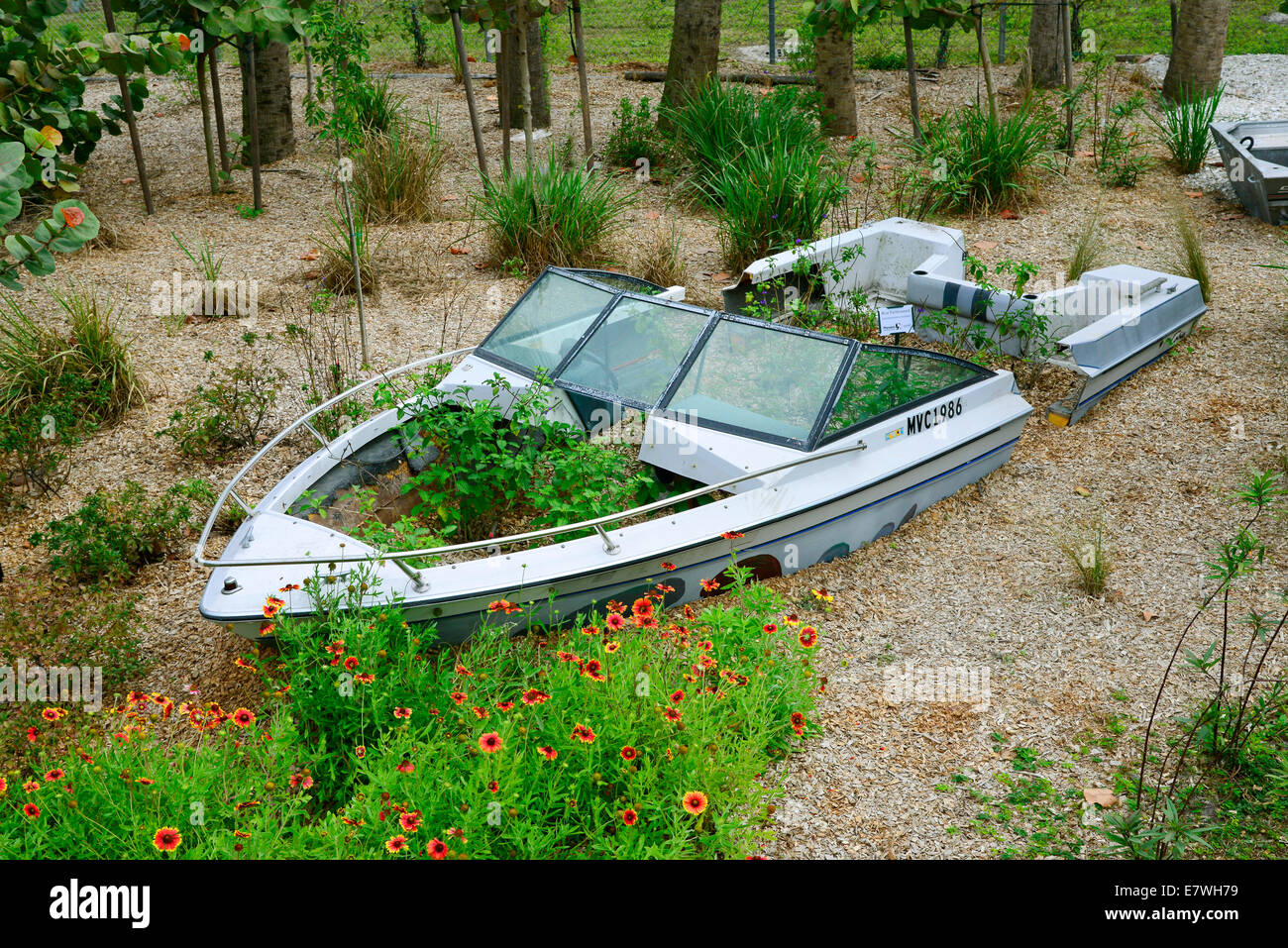 Small boat canoe used in a landscaping garden Stock Photo Alamy