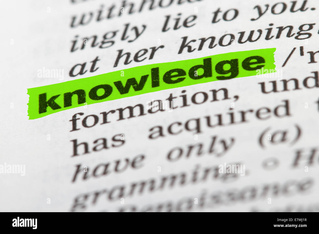 Knowledge word highlighted with green marker on dictionary page Stock