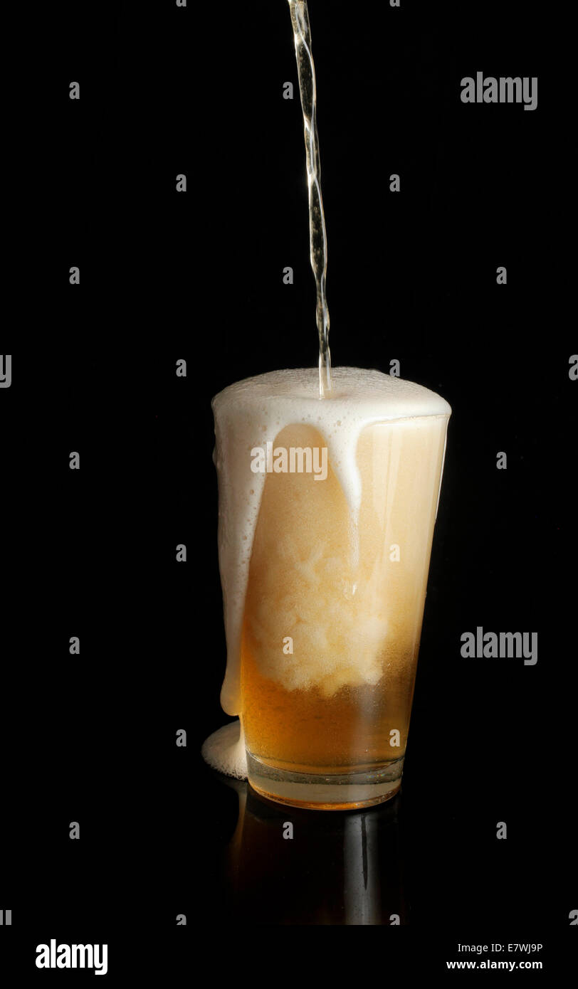 Overflowing beer glass Stock Photo