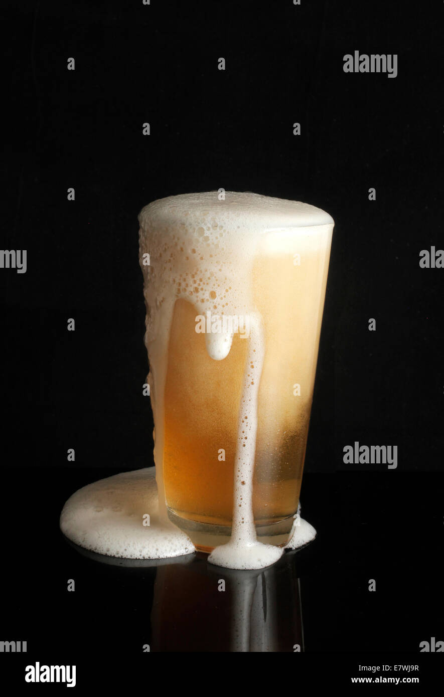 Overflowing beer glass Stock Photo