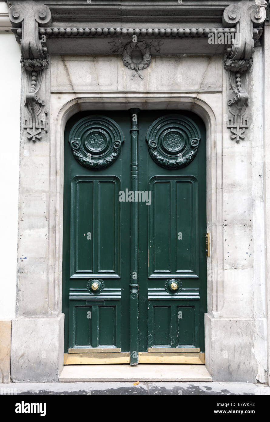 Dark green wooden door in old building facade. Paris, France Stock Photo