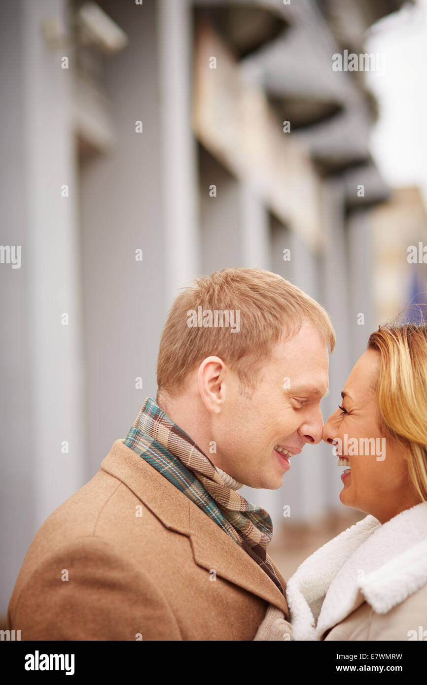 Portrait of amorous man and woman laughing outside Stock Photo - Alamy