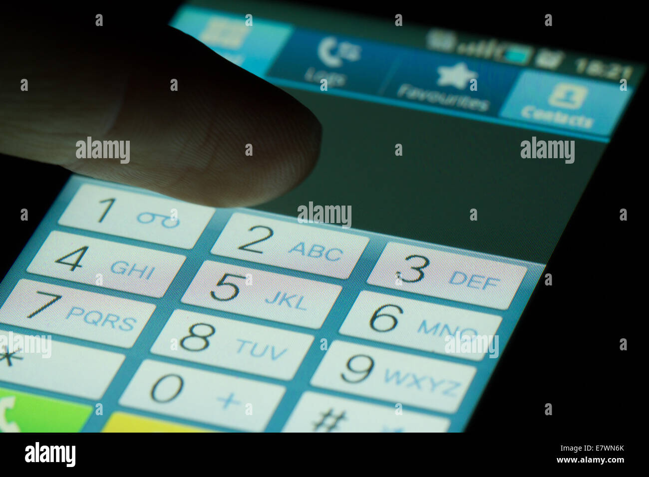 Finger touching dialing numbers on dark Stock Photo - Alamy