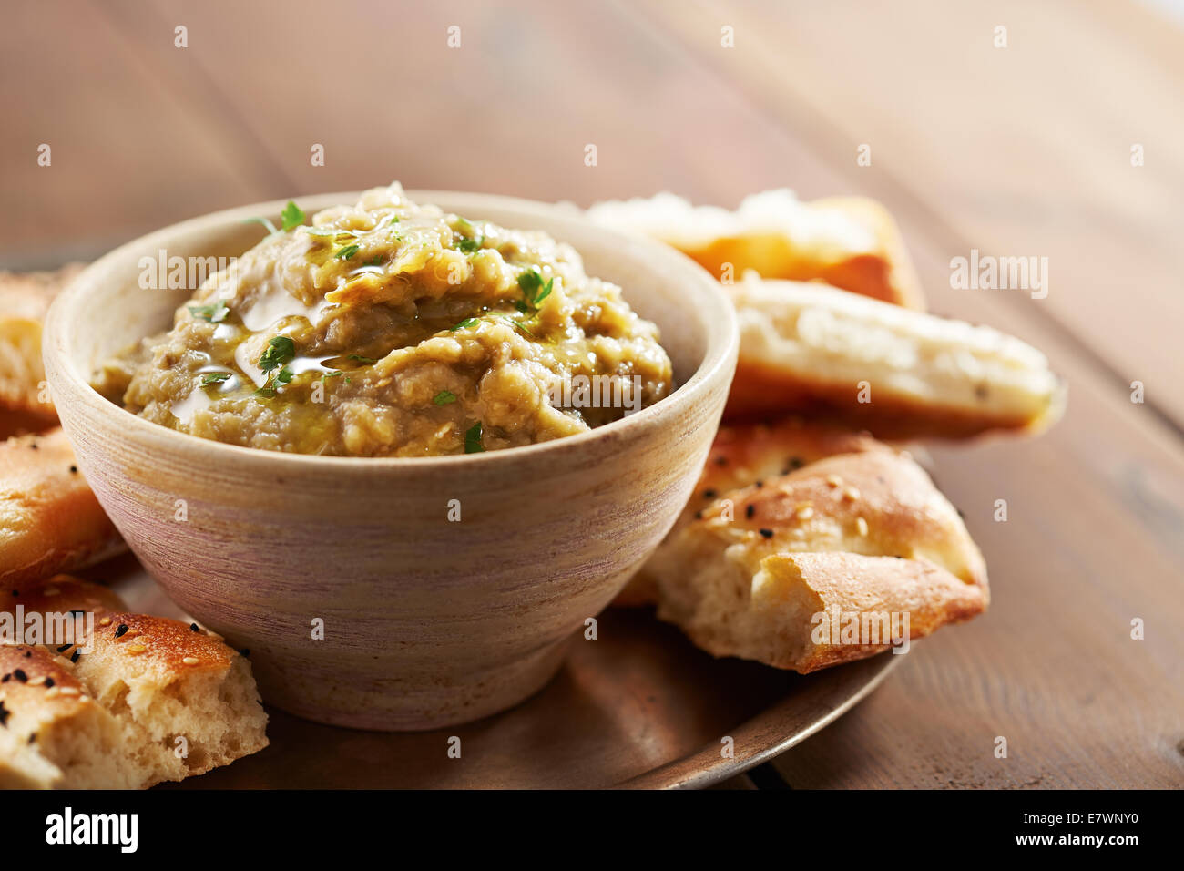 Eggplant baba ganoush with flat bread and herbs Stock Photo